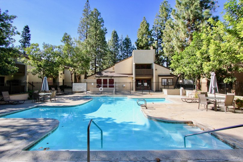 A sunny day in front of pool with table chairs in Quail Creek community, Mira Mesa, CA