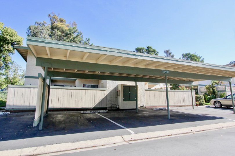 A sunny day in the area of Quest, outside, car port, nehicles, trees, gutter