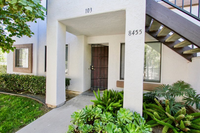 A building with white painting in villas at New Salem, stairs and metal doors provided.