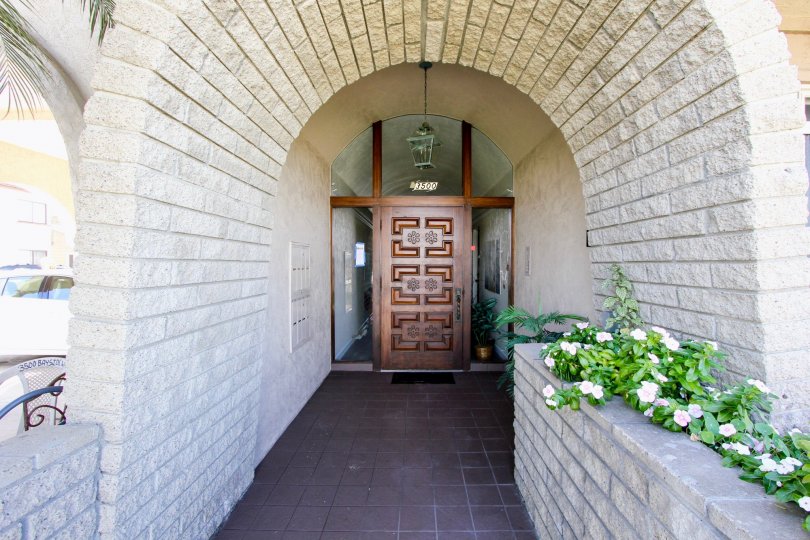 Flowers and an archway leading to 3500 Bayside Walk in Mission Beach, CA