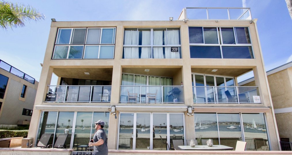 The complex and views of the building reflected in the modern villa in Mission Beach California