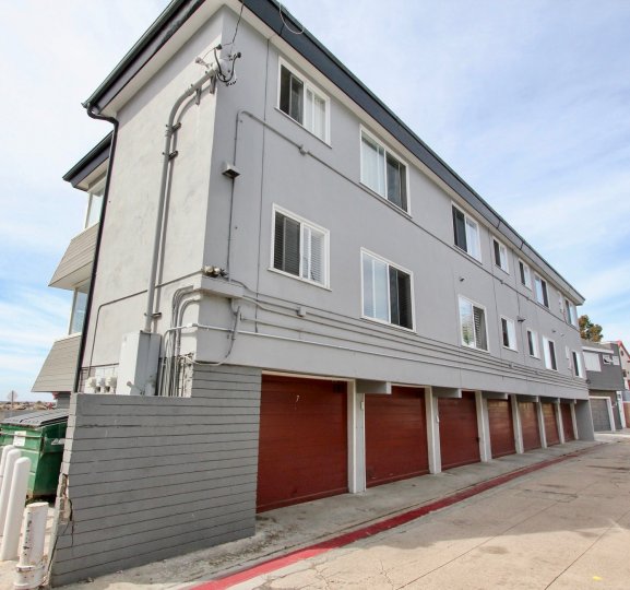 White Two story apartments with parking garages beneath