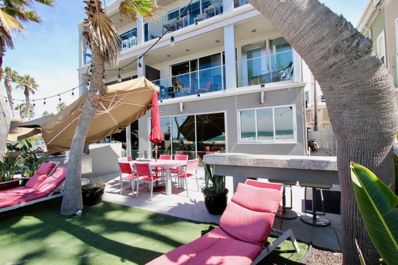 Pink lounge chairs sit on AstroTurf at South Beach condos