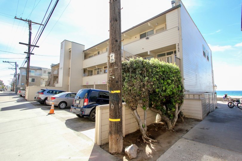 An exterior view of the Top of the Beach oceanside apartment complex on a sunny afternoon in the Top of the Beach neighborhood.