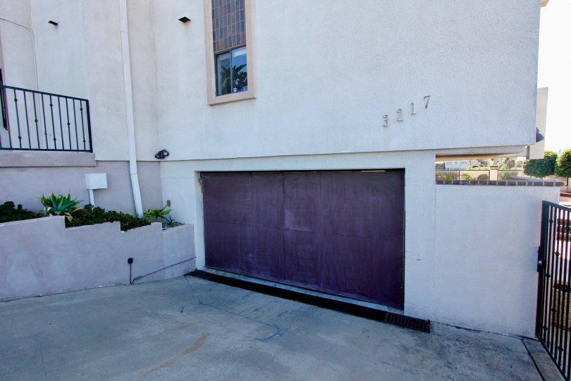 A sunny day in the area of Columbia Heights, garage, fence, plants, window