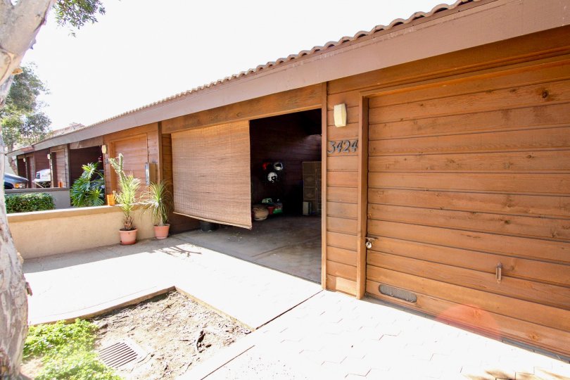 Near the Opened door has two flower pots and covered the room with roof