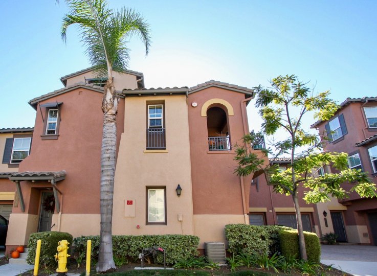 A yellow fire hydrant sits in front of a townhouse at the Courtyards at Escala.