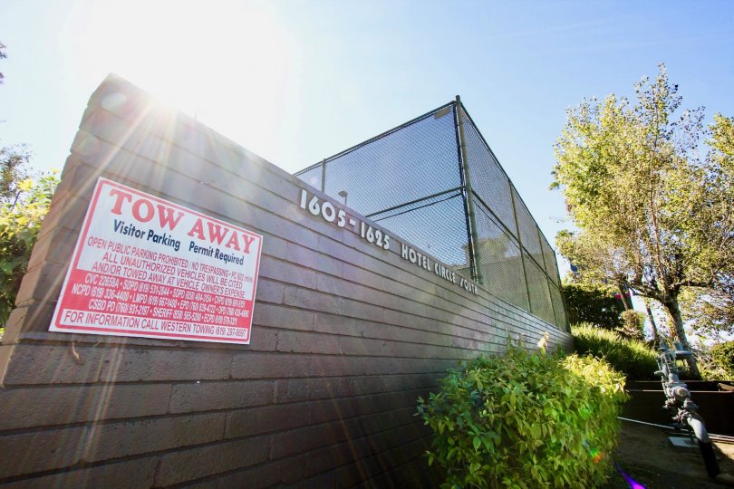 A sunny day in the area of Mission Village, tow away dign, windows, trees, statue