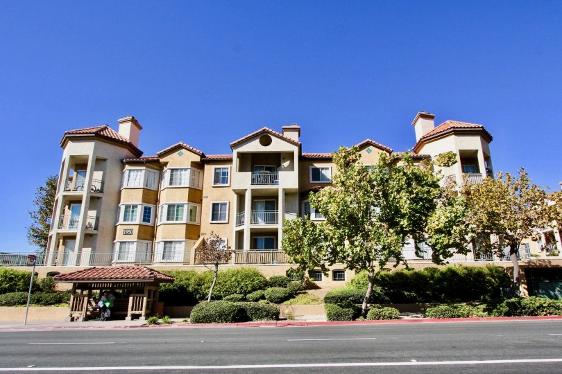 A three story property with porches on a clear day in River Colony
