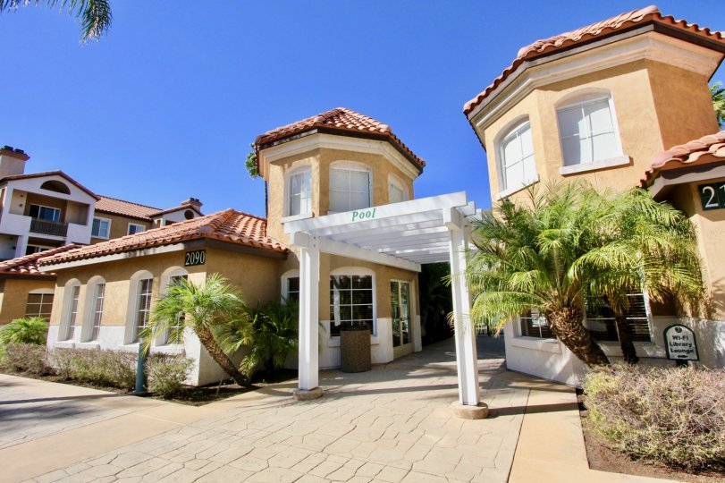 Image of stucco buildings against a blue sky: the River Colony community in Mission Valley, California.