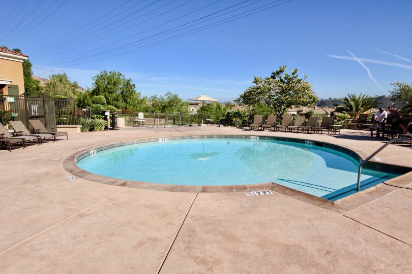 A beautiful day at the pool in the Terraces at Escala neighborhood with powerlines and trees.