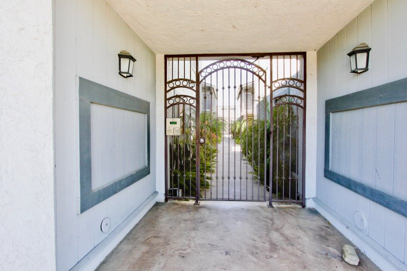 An entrance place with a grilled gate with lights in a villa in Cherokee Court of Normal Heights