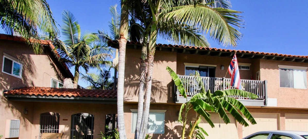 Condo, Nice balcony, garages available, gated entrance, mailboxes, palm trees, tile roof, stucco exterior