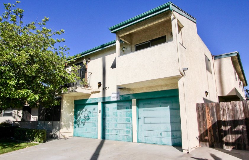 A sunny day in the area of Hamilton Street Condos, garage, wooden fence, balcony, trees, driveway