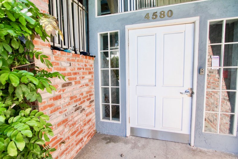 Short white door with address above it at the Madison Ave in Normal Heights CA