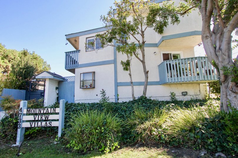 A low-rise unit in Mountain View Villas community painted in blue and white.