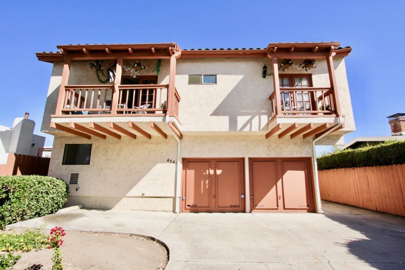 A traditional two-storey house in the North Felon community with orange doors and railings.