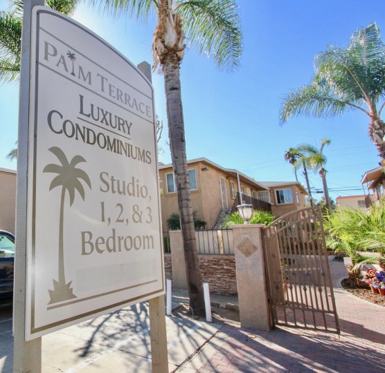 THE PLAM TERRACE CONDOMINIUMS IN THE PALM TERRACE WITH THE NOTICE BOARD, LAMP, TREES, PLANTS