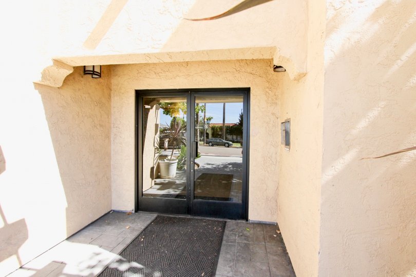 The sunny reflection of the street in the entrance to Plaza Arizona in Normal Heights, California.