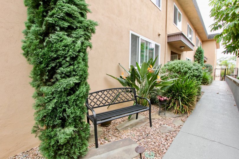 Exterior of apartment building at 4154 Louisiana Street with bench and plants