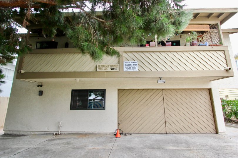 Tan 2 Story House with large balcony and double car carage.  Cement driveway for parking also.  Located in Alabama Villas in North Park, CA