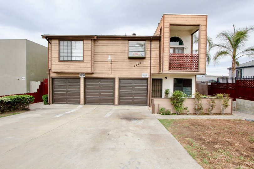 Two story residential building with attached garages at Oregon Court in North Park California