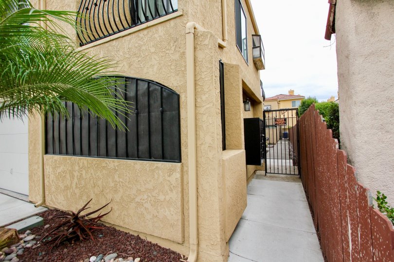 A sunny day in the area of Sunflower, condos, gated entrance, palm tree, fence