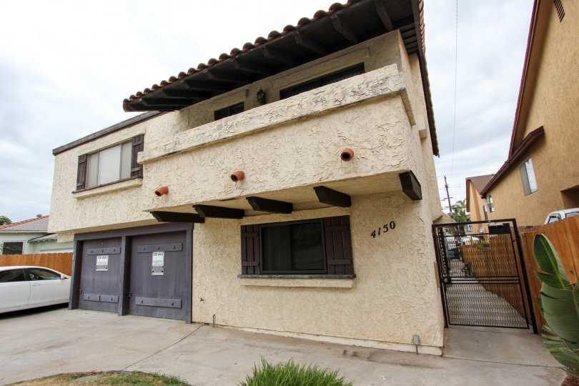 A sunny day in the area of The Alamo, condo, gated entrance, garage, car
