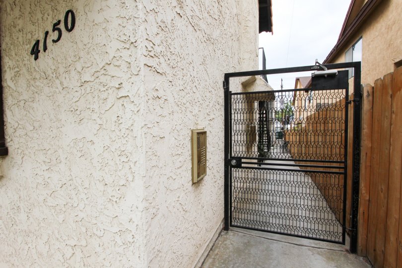 A fence door and someones address on a gloomy day In California