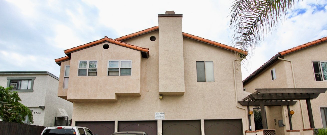 Outside view of a cream colored unit with a chimney located in Villa Park of North Park, California