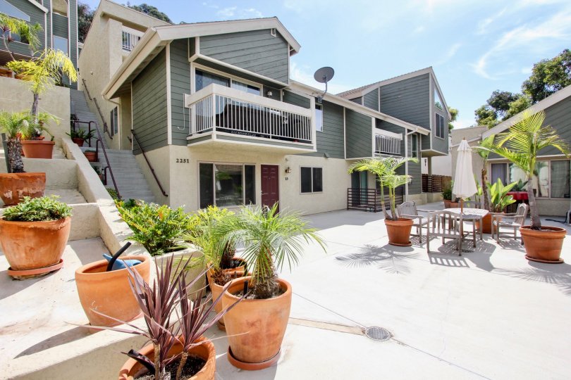Large expansive courtyard with potted plants and outdoor seating with terraced gardens at Bay Pointe