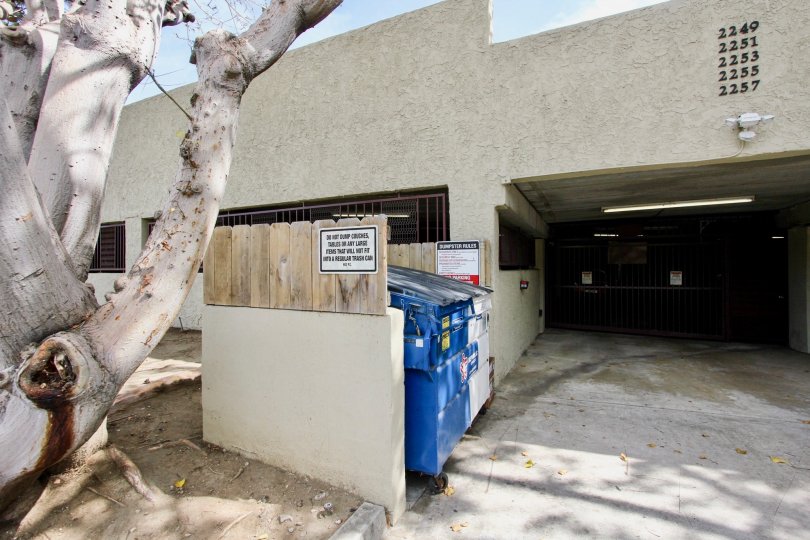 Gray building with a garbage collector in Bay Pointe neighborhood