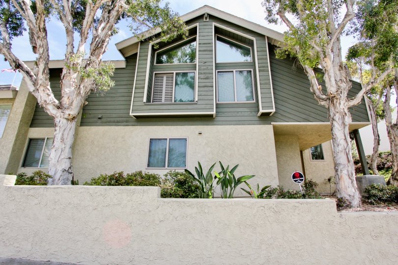 A two-storey house painted in green in Bay Pointe village.