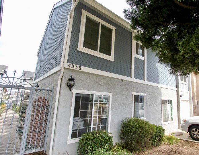 THE 4338 BUNGALOW IN THE MONTALVO VILLAS WITH THE CAR PARKING, TREE, GRASS.