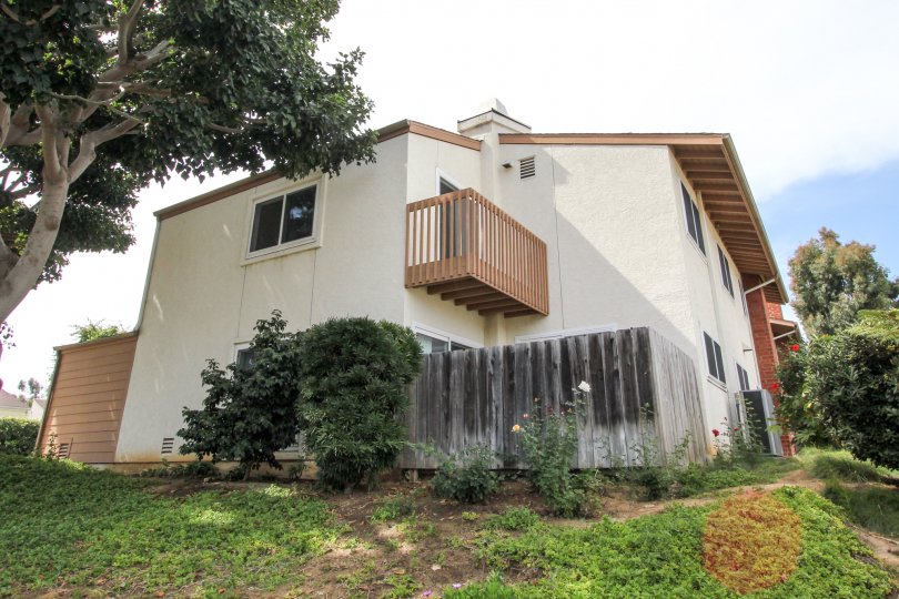 Two-story home on a hill with small second floor balcony, in Park Point Loma, Ocean Beach, California.