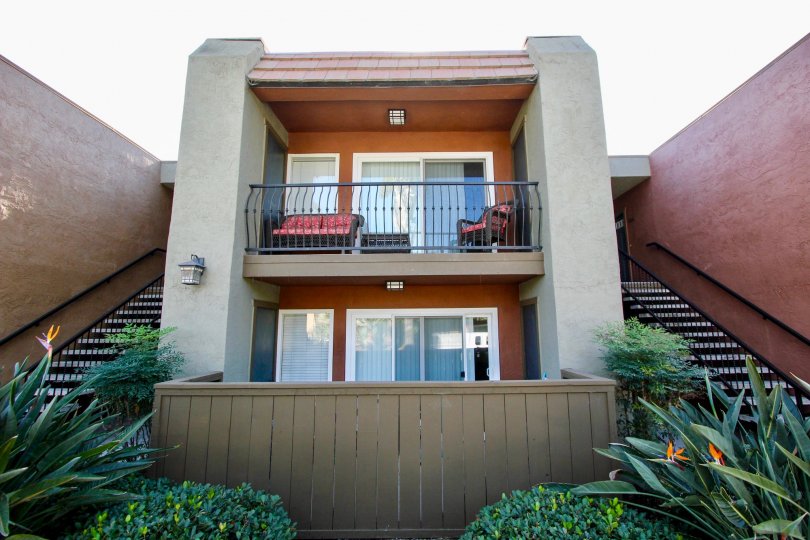 A sunny day in the area of La Estancia, condo, outside, balcony, couch, chair, bushes, stairs