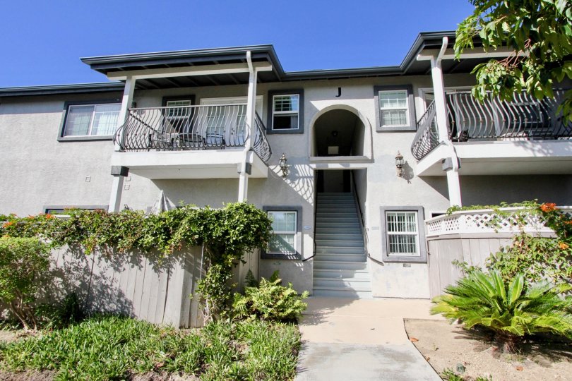 Charming facade sourrounded by lush greenery at Las Brisas in Oceanside, California.
