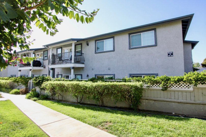 Condo row houses in Las Brisas with attractive landscaping, fencing, and trees
