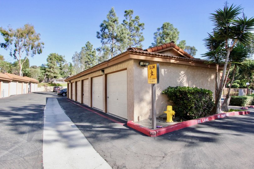 A cross road and a side view of a house with SLOW sign board at Loma Alta Village