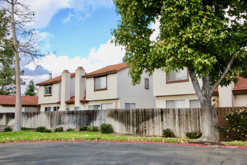 A stained wood privacy fence surrounds the Mission Meadows townhomes