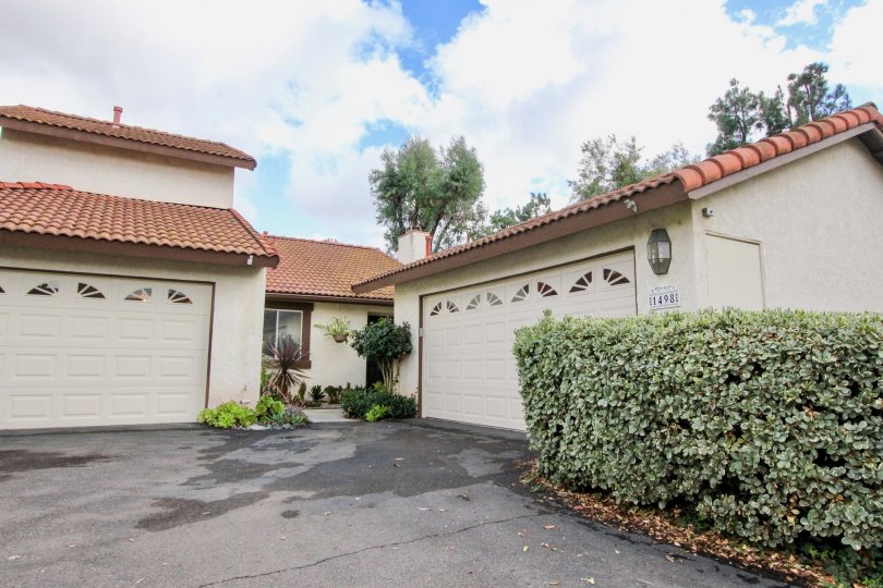 Two house garage and big space outside with plants in Mission Meadows