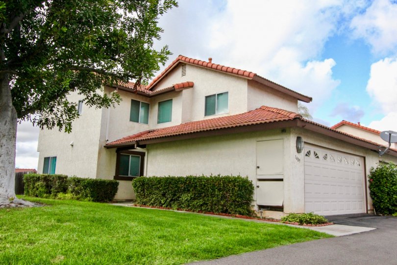A pleasant day in Mission Meadows neighborhood with house garage and green grasses