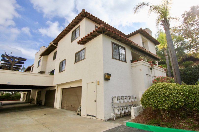 Three story brown housing with gas meters on the side at Mission Point Townhomes in Oceanside CA