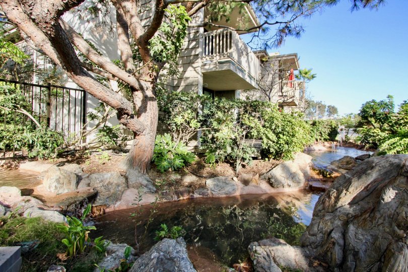 Gorgeous professionally landscaped backyard with prominent water feature and 2nd level balconies in North Coast Village, Oceanside, CA