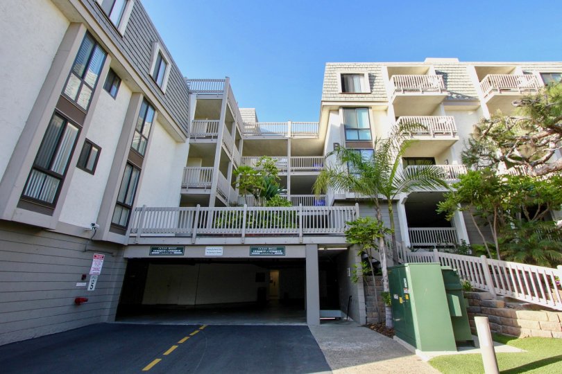 A shaded parking lot entrance to an North Coast Village apartments in Oceanside, CA.