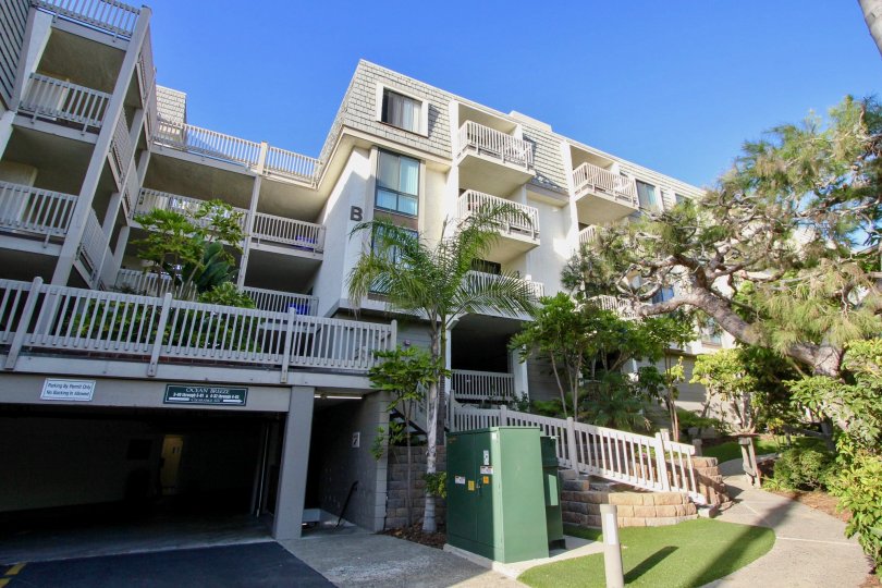 A four story town home complex with a garage for parking inside North Coast Village in Oceanside CA