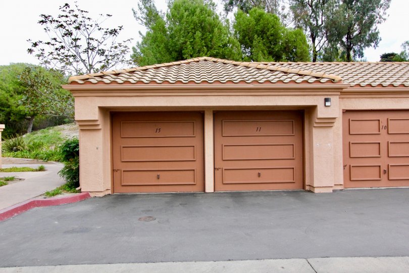 A sunny day in the area of Palmilla Del Oro, outside, trees, sidewalk, garages, light