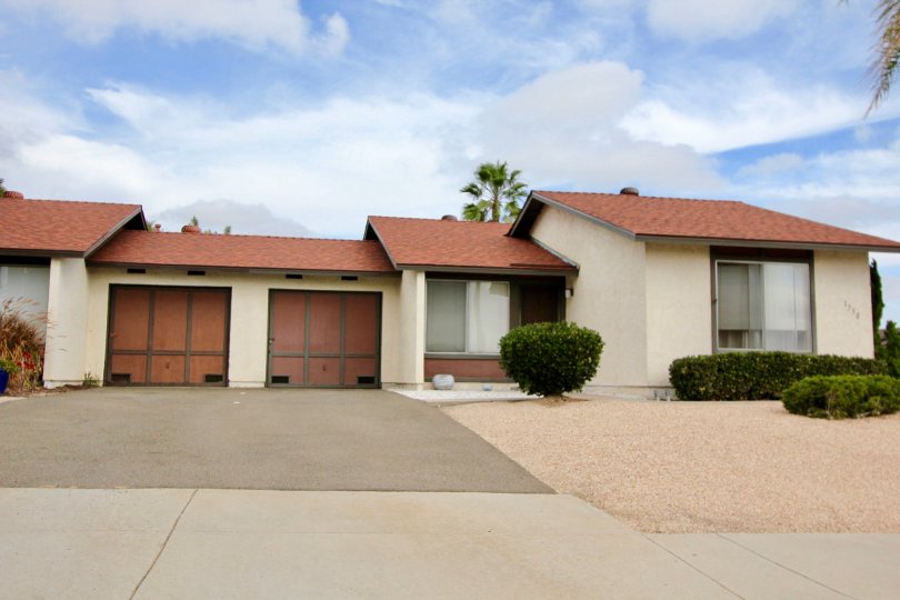A sunny day in the area of Peacock Hills, outside, garage, door, driveway, sidewalk, bush