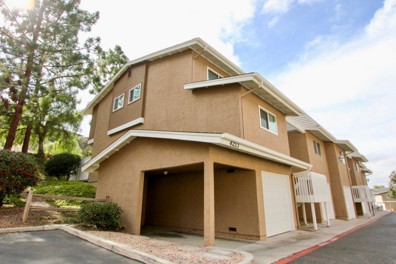 A sunny day in the area of Quail Ridge, garage, covered entrance, trees, outside, wooden fence
