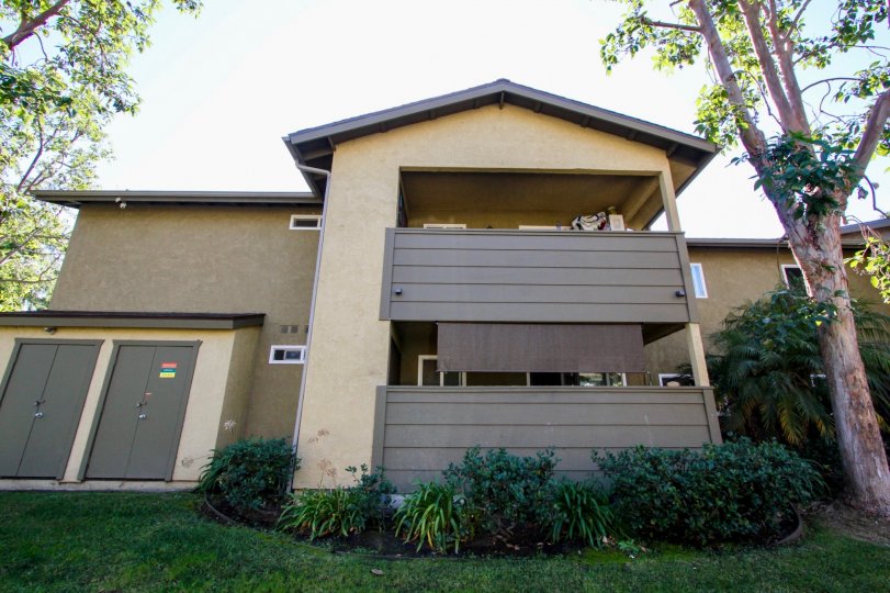 Two story town homes with brown patios inside River Trail at Oceanside CA